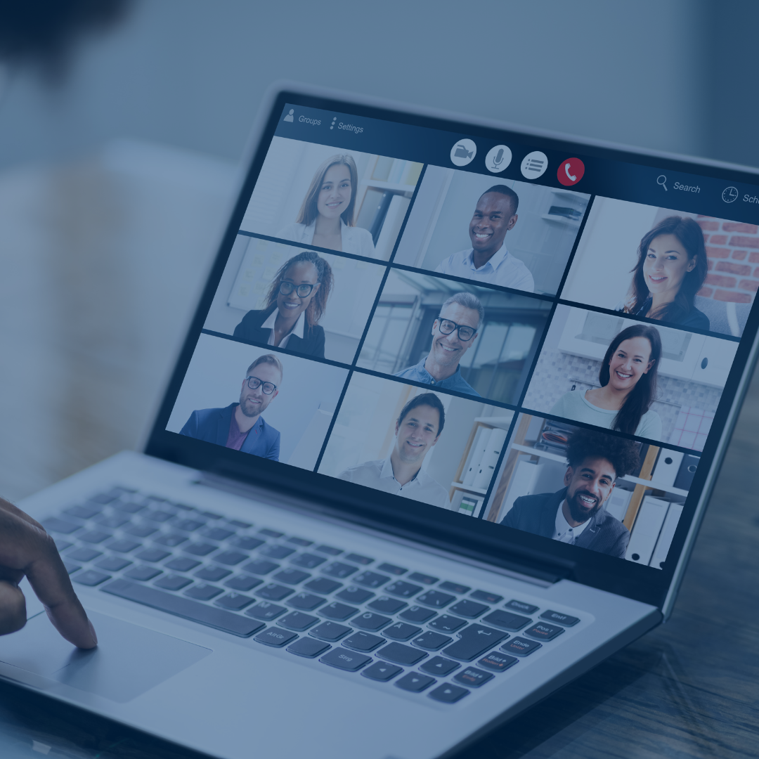 A laptop screen displaying a video conference call with seven meeting participants in full or partial view